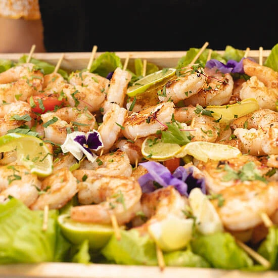 Prawn skewers on a platter, held by our wait staff at birthday party