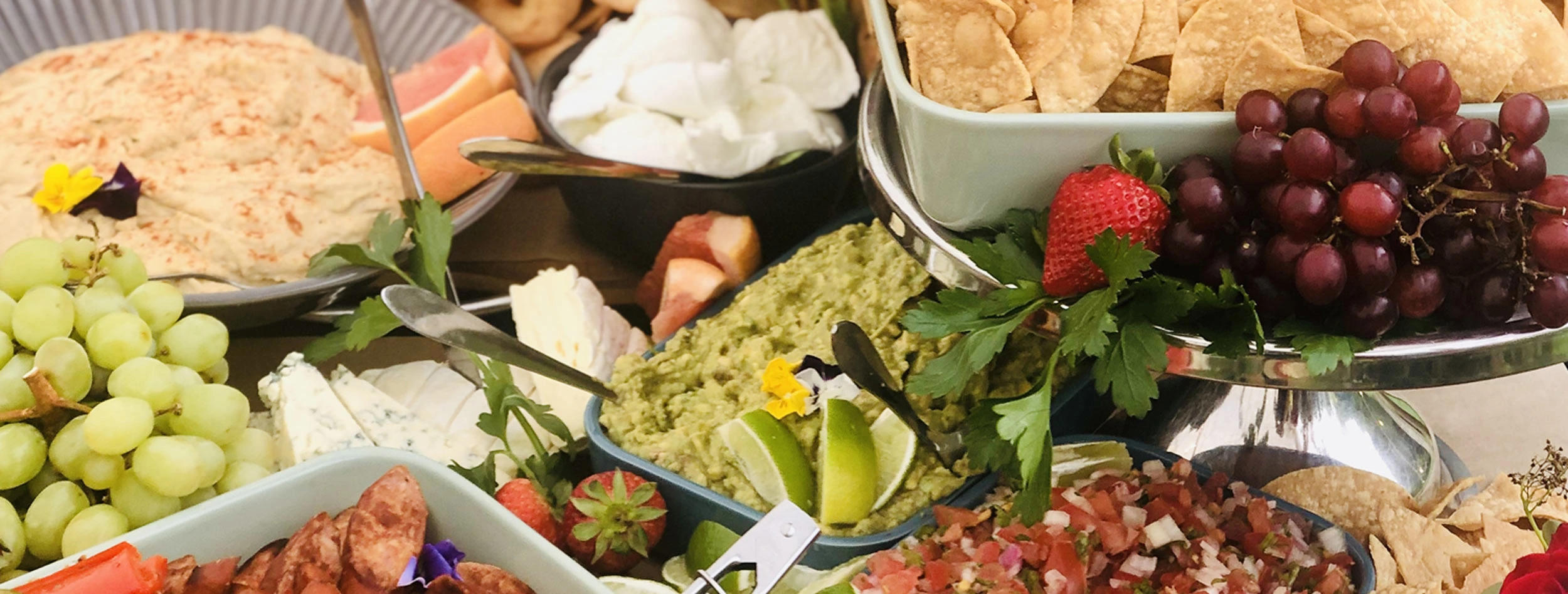 Our grazing tables - House made guacamole, pico de gallo salsa, hosue made hummus la tortilleria corn chips, fresh fruit. Beautiful presentation making it a talking point at any event.