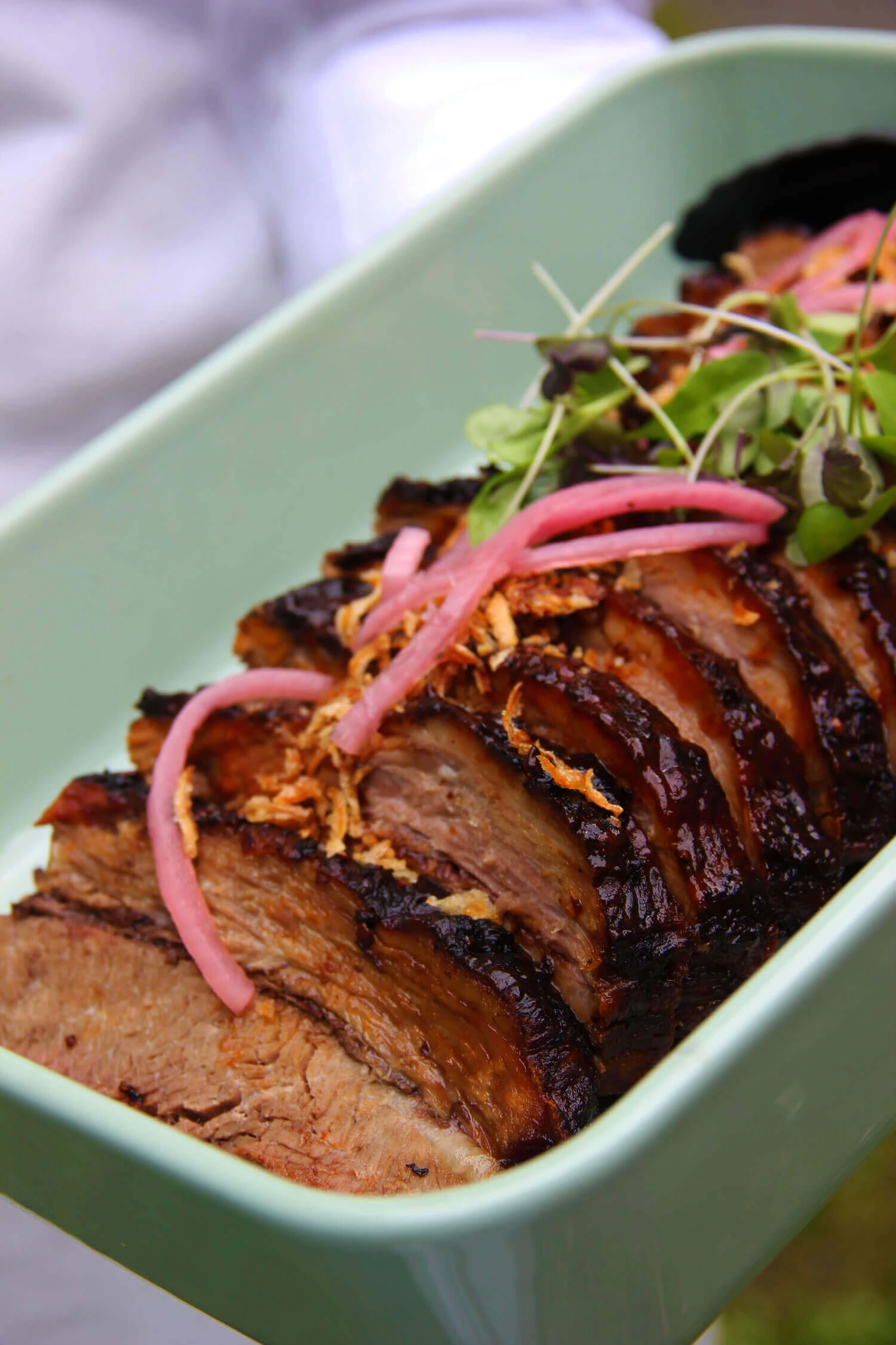 A Sharing plate of Smoked beef brisket served in the middle of the table for guests to share